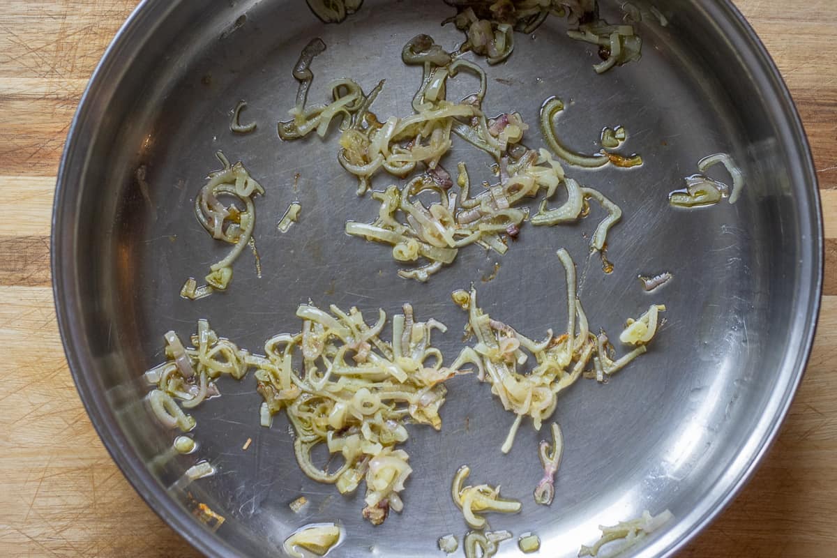 sautéing the shallots in a pan with olive oil
