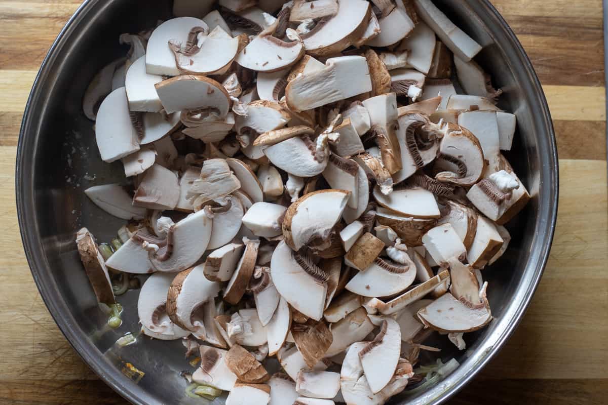 sliced mushrooms are added to the pan
