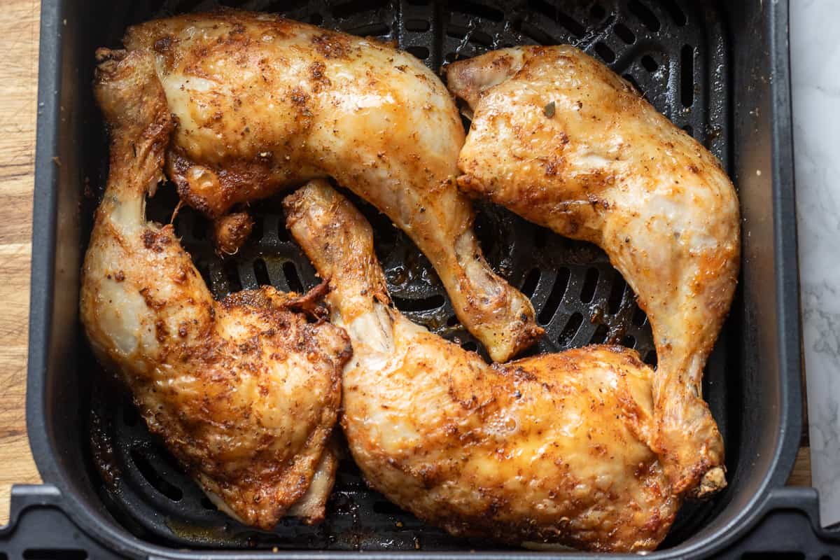 chicken legs are cooked in air fryer until crispy