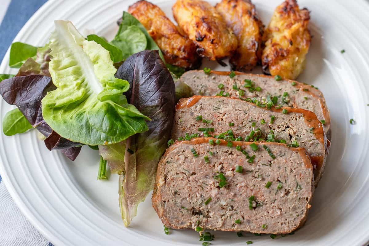 air fryer meatloaf sliced and served with salad