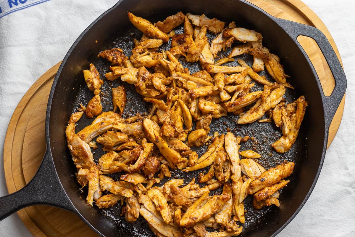sliced chicken shawarma sautéed in a skillet