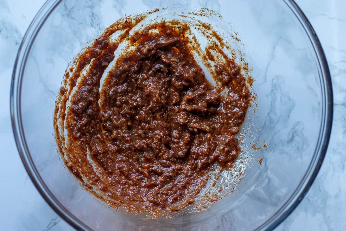 marinade ingredients for homemade chicken shawarma are mixed in a bowl