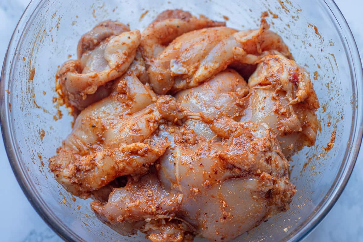 chicken thighs are covered with marinade