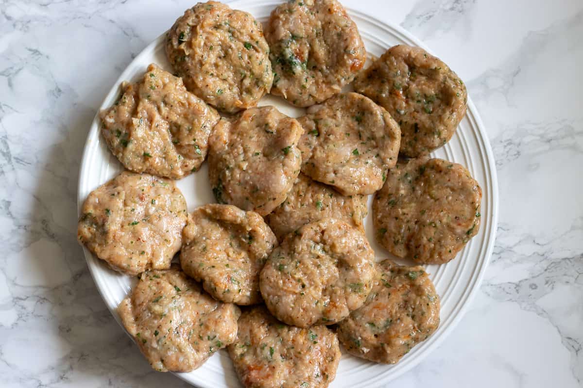 14 pieces of chicken kafta patties on a plate