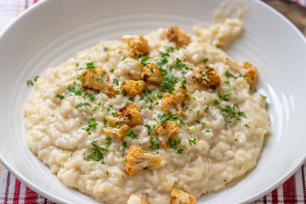 creamy cauliflower risotto served with garnishes