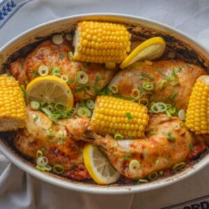 peri peri chicken served with corn on the cob and lemon slices