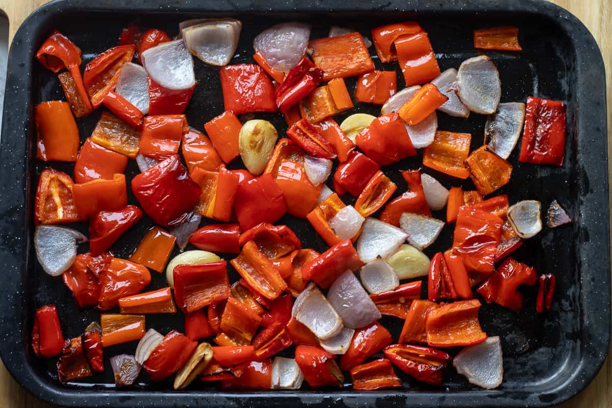 roasted chopped onions, red peppers, red chilies, and garlic placed on a tray