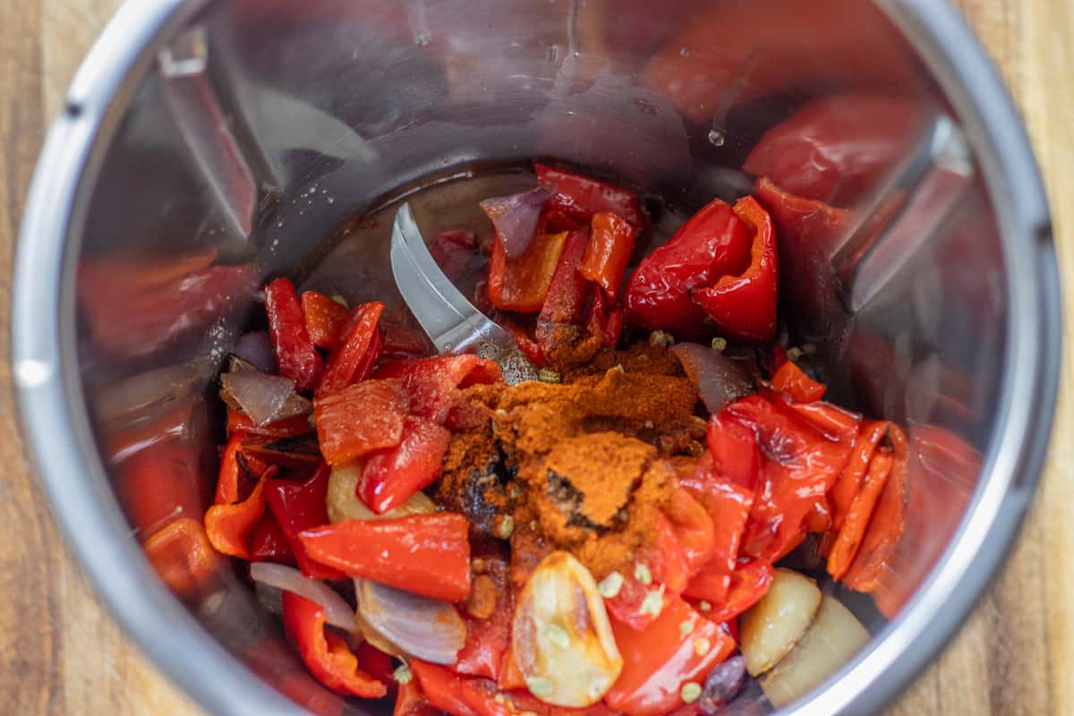 roasted vegetables, and flavourings are added to a bowl of a food processor