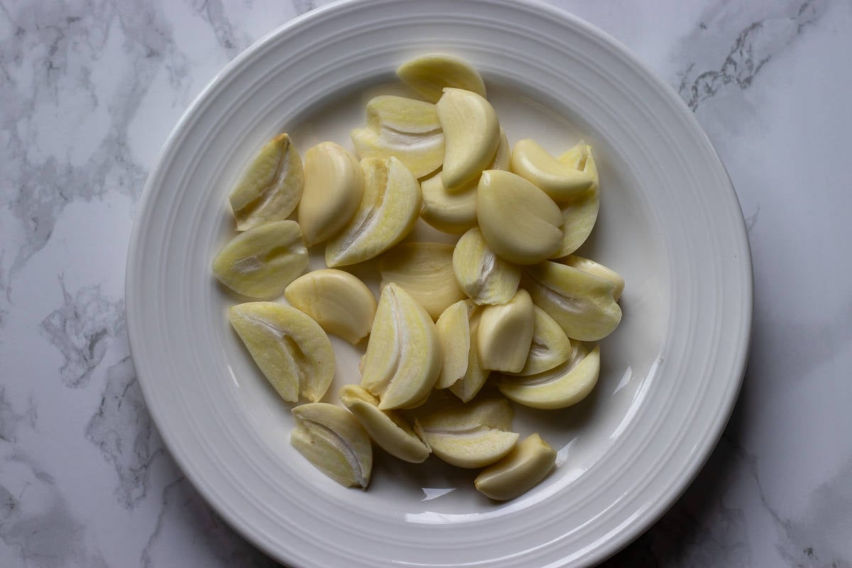 garlic cloves are peeled and the green sprouts are removed