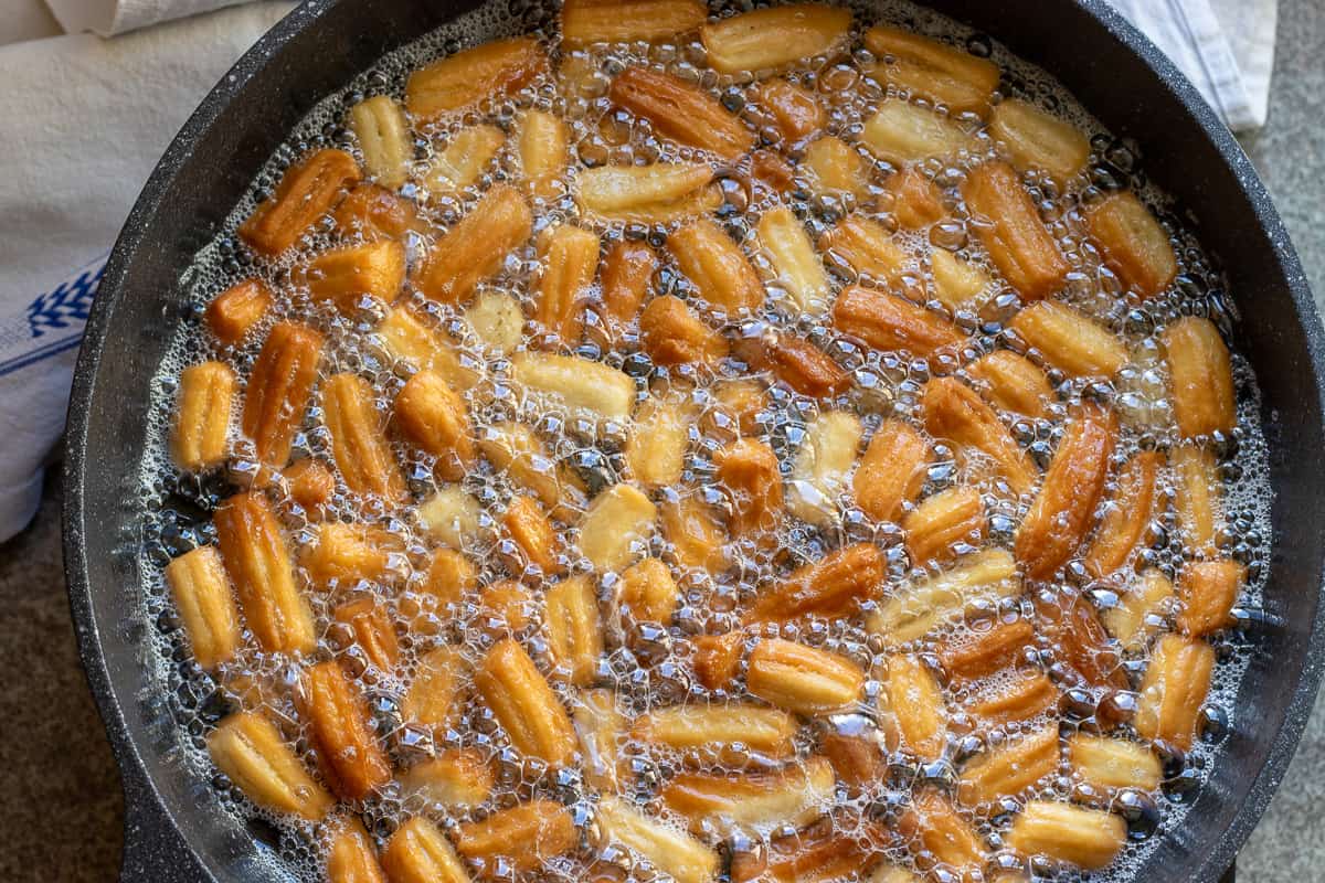 dough pieces are brown and crispy, ready to dip in syrup