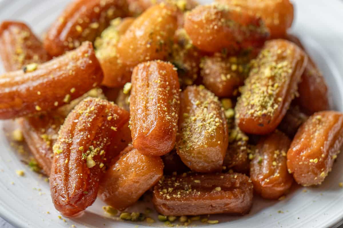 tulumba dessert garnished with chopped pistachio