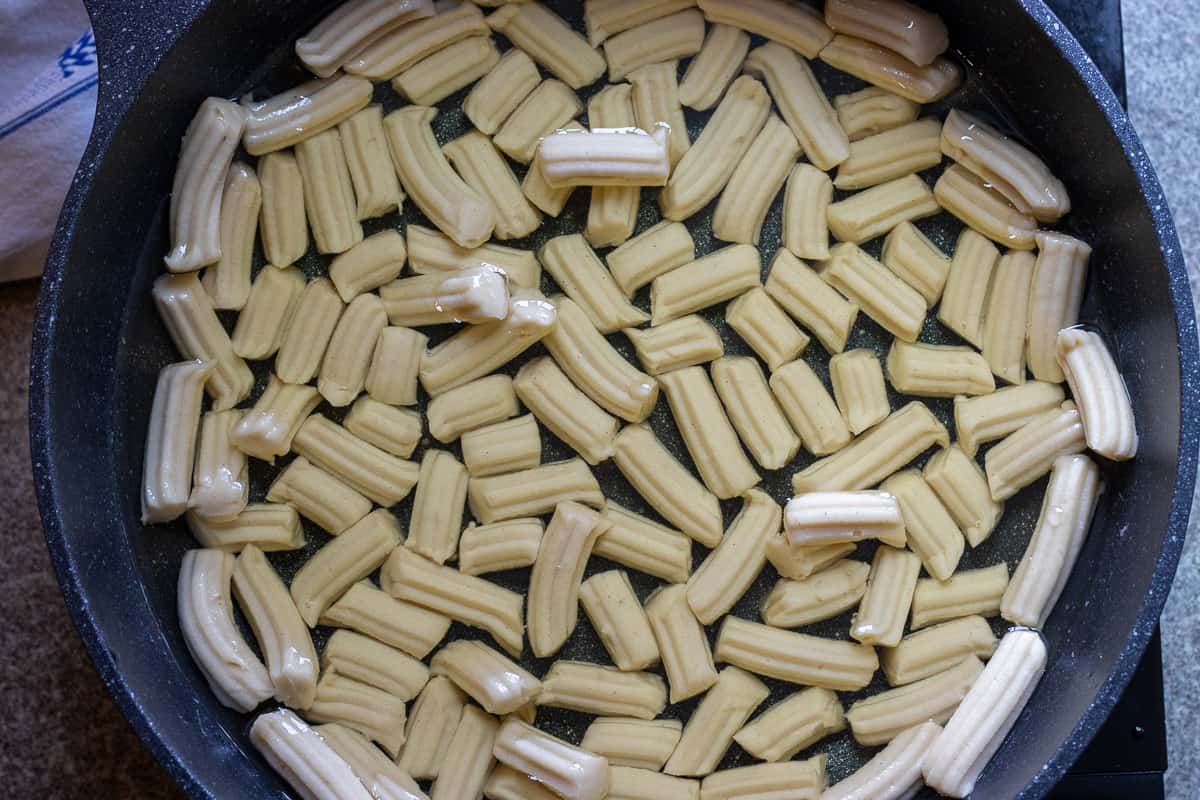 tulumba dough is piped in cold oil