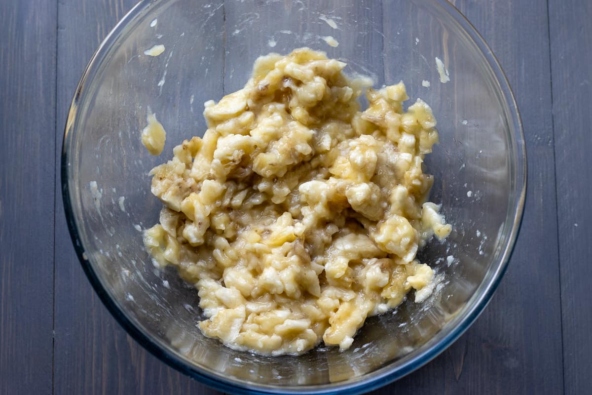 ripe bananas are mashed in a bowl