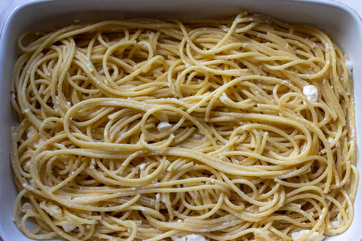 cooked pasta is layered on a baking dish