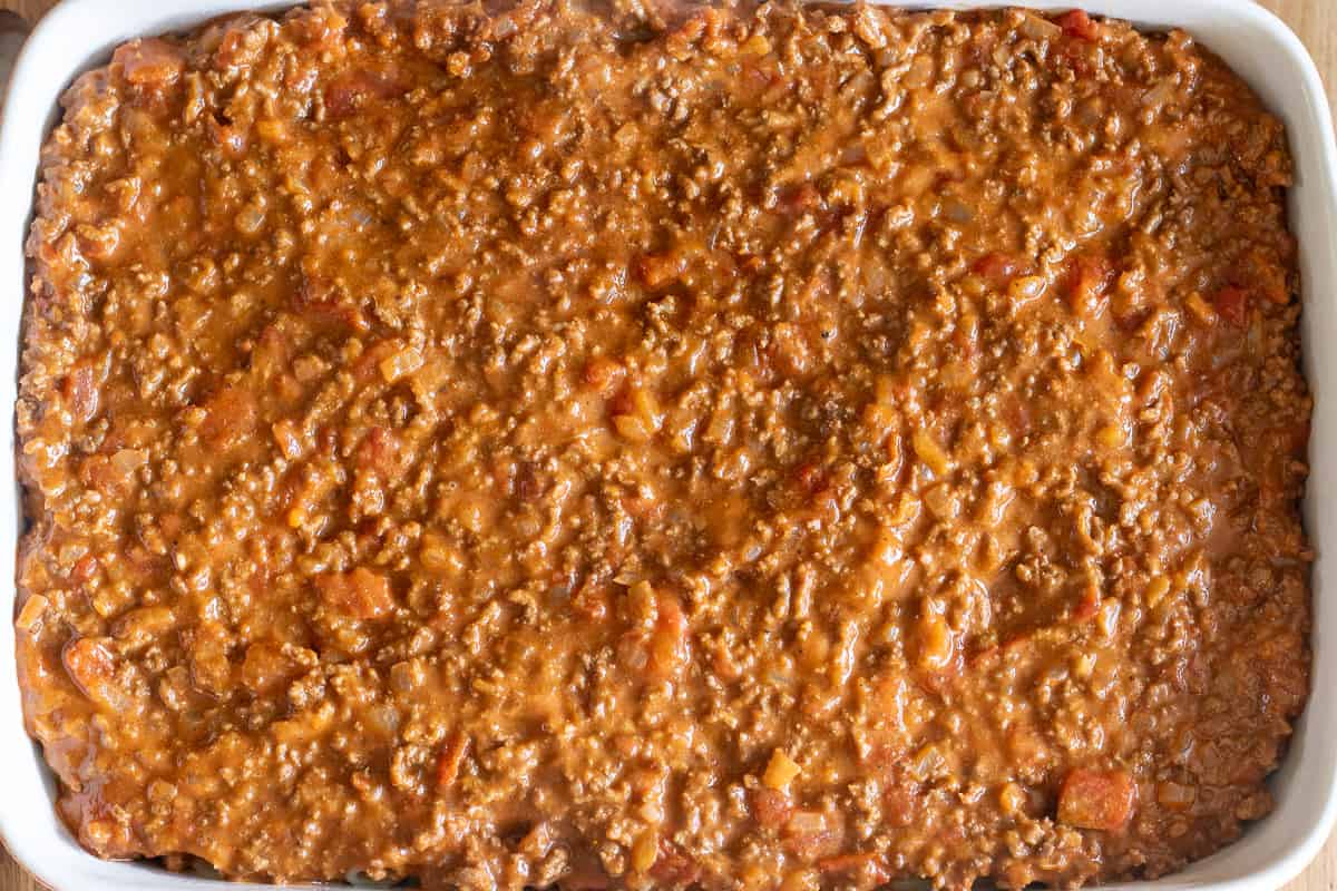meat sauce is layered on top of pasta