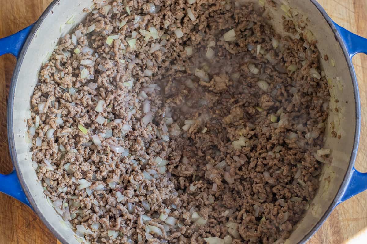 red wine is added to sautéed meat and onions