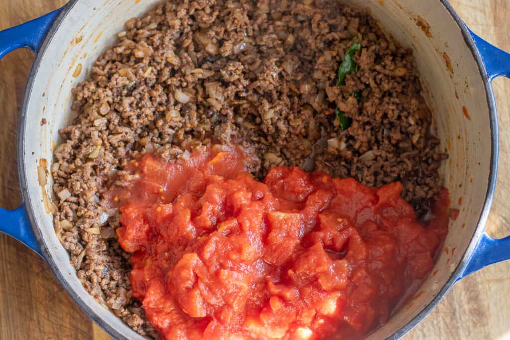chopped tomatoes are added to the pan