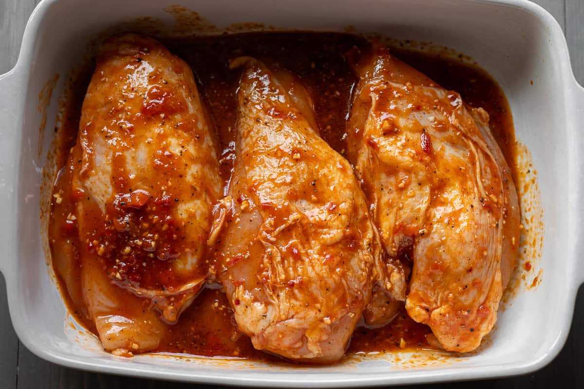 chicken breasts are placed in a baking dish