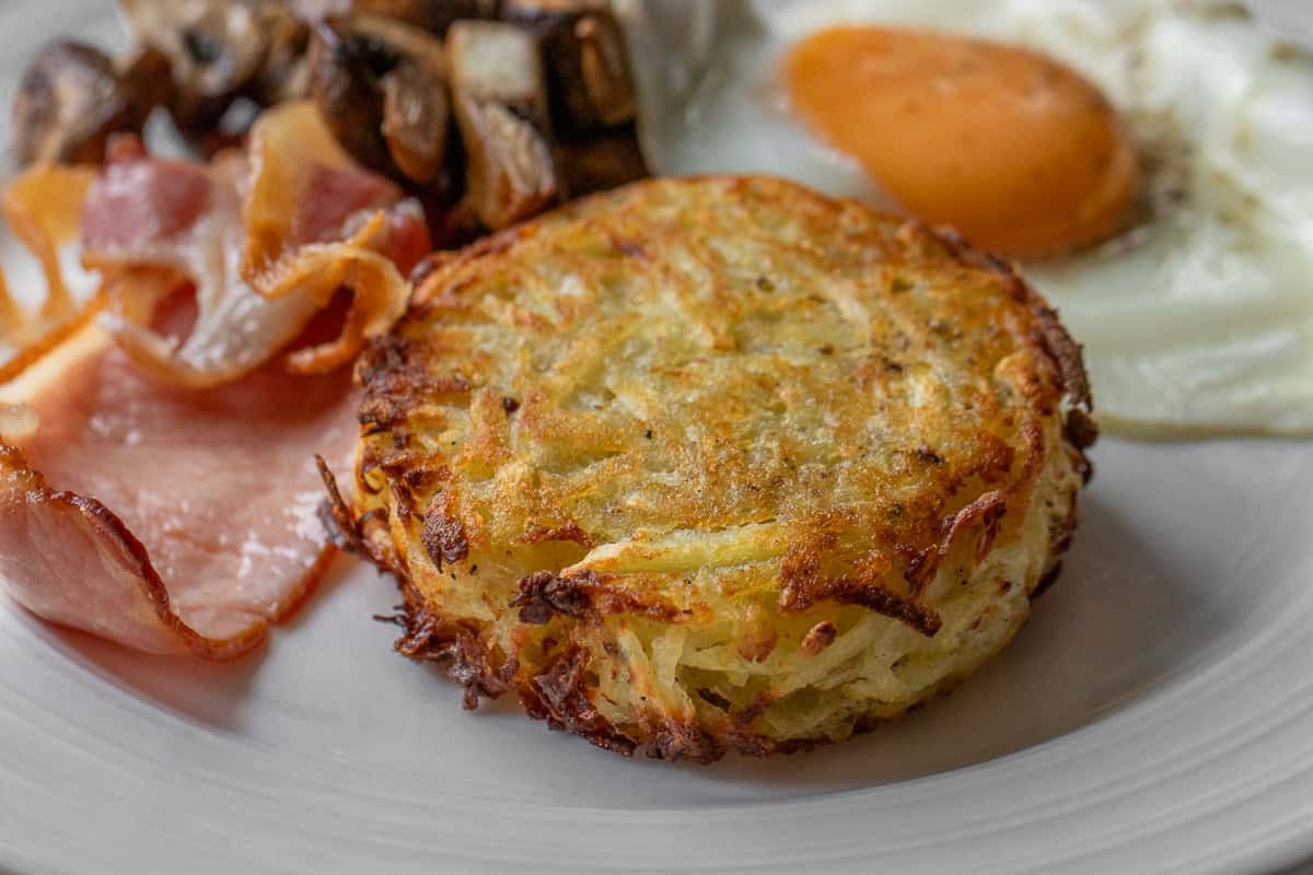 air fryer hash brown patty served with bacon and eggs