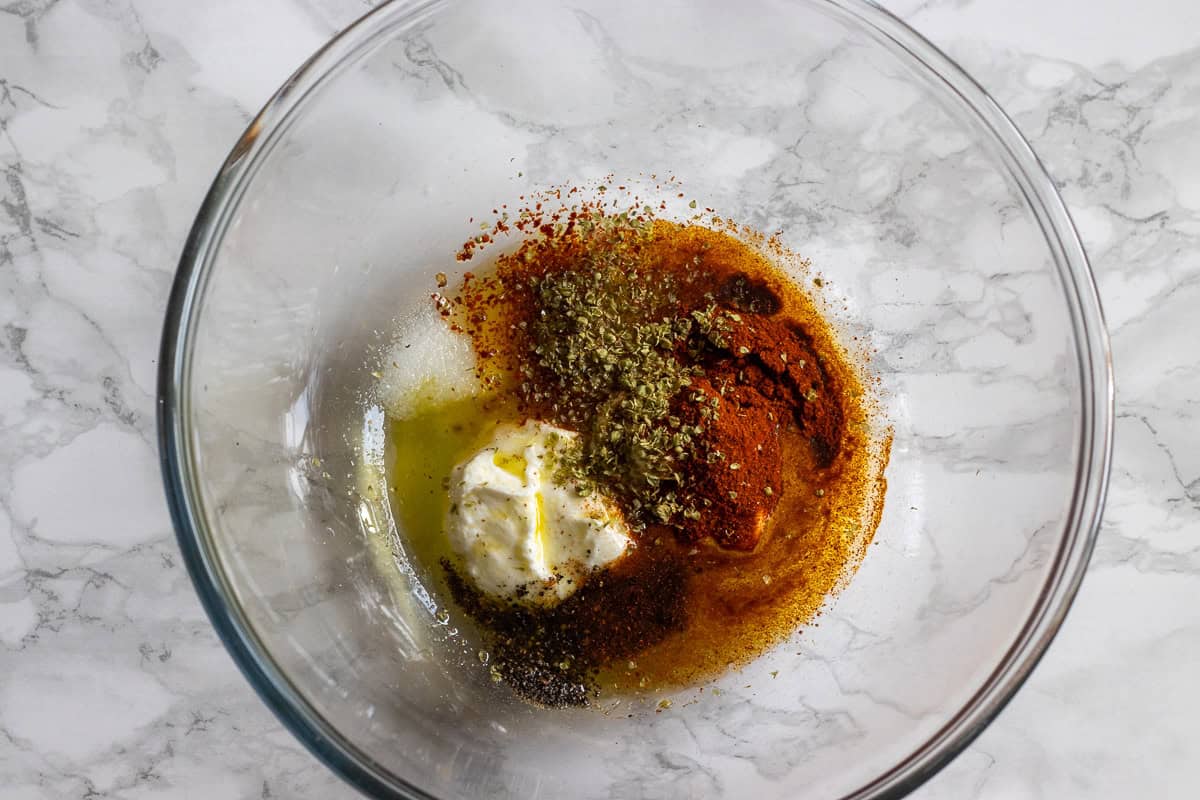 ingredients for marinating chicken thighs in a bowl