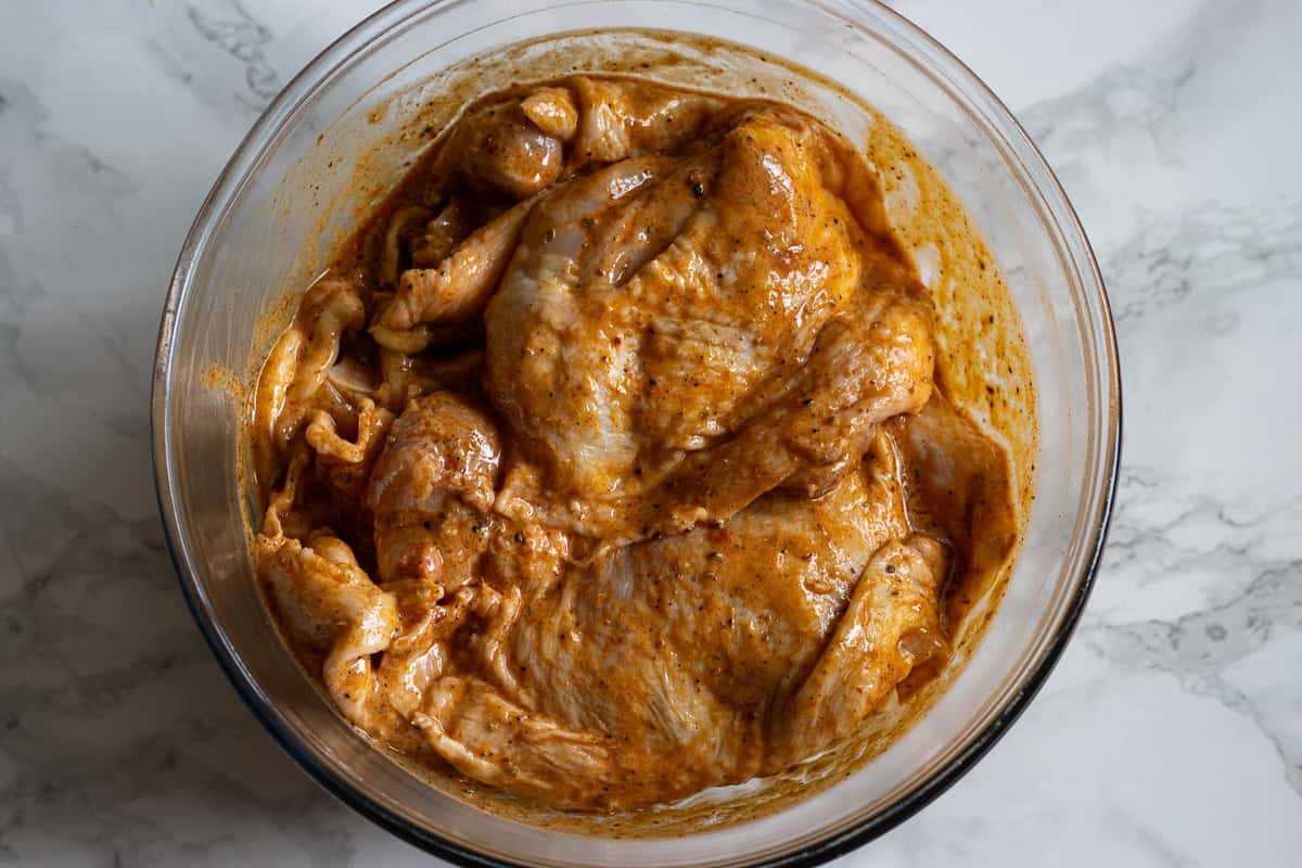 chicken thighs are covered with marinade