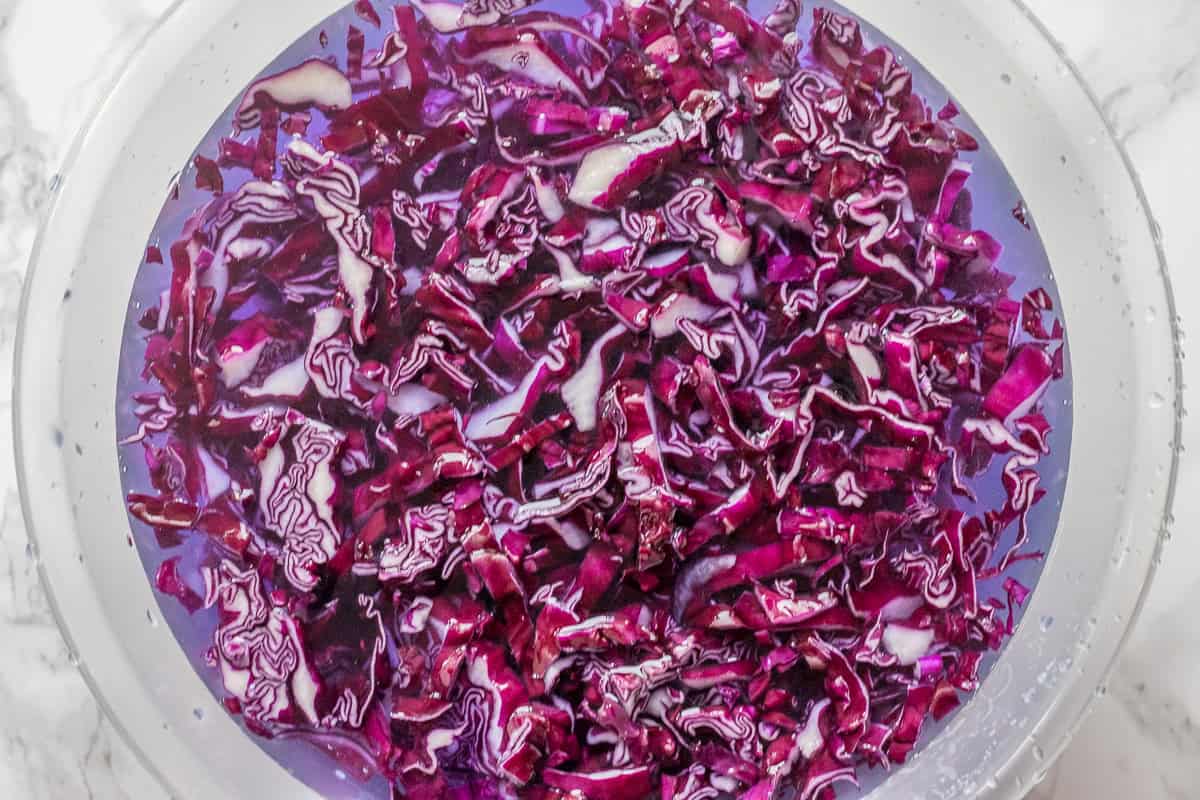 shredded red cabbage in cold water