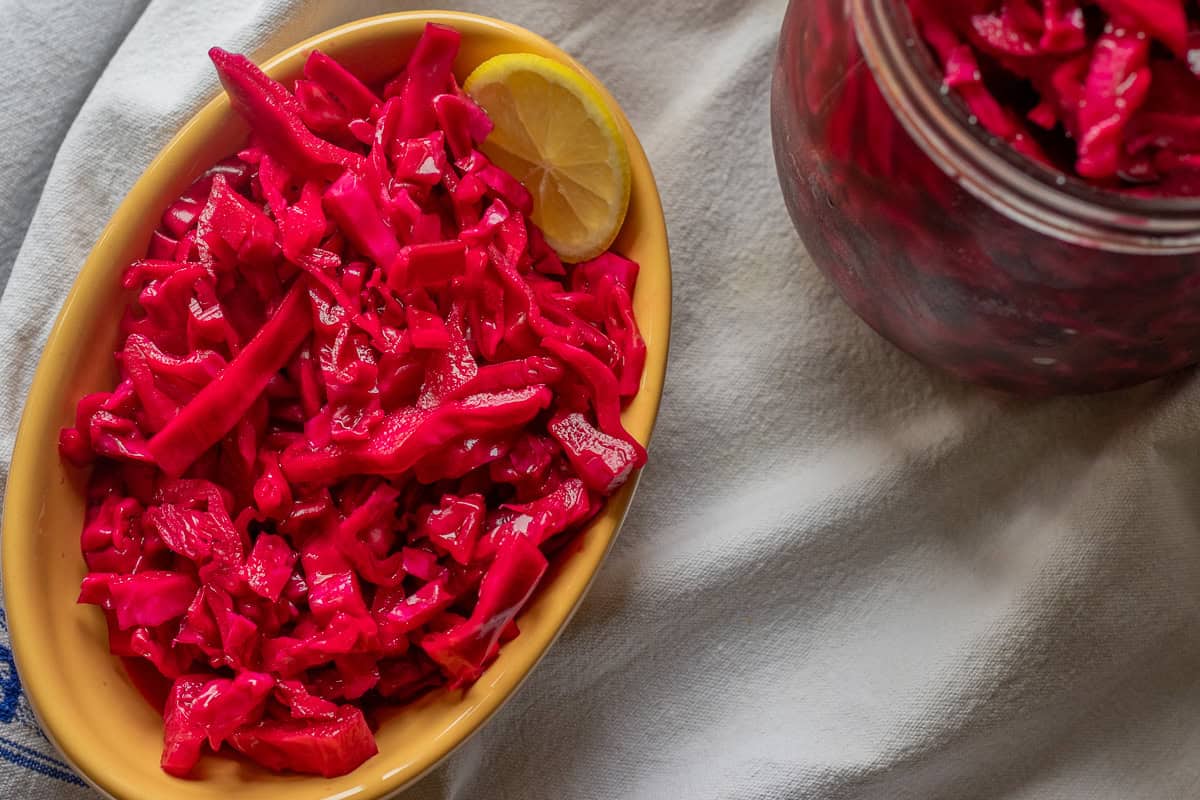 pickled red cabbage served with a slice of lemon