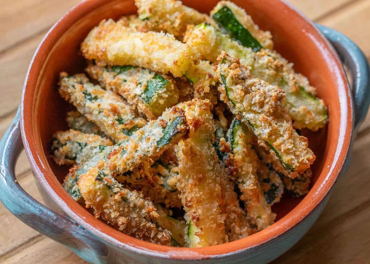 A bowl filled with fried zucchini sticks