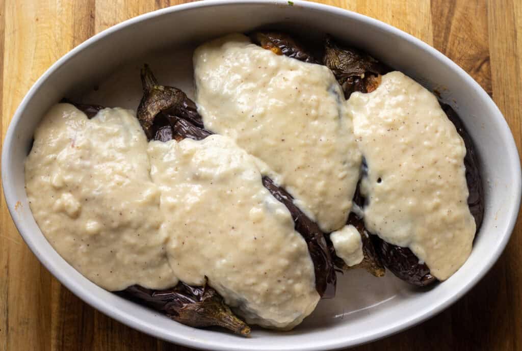 stuffed eggplants are topped with béchamel sauce
