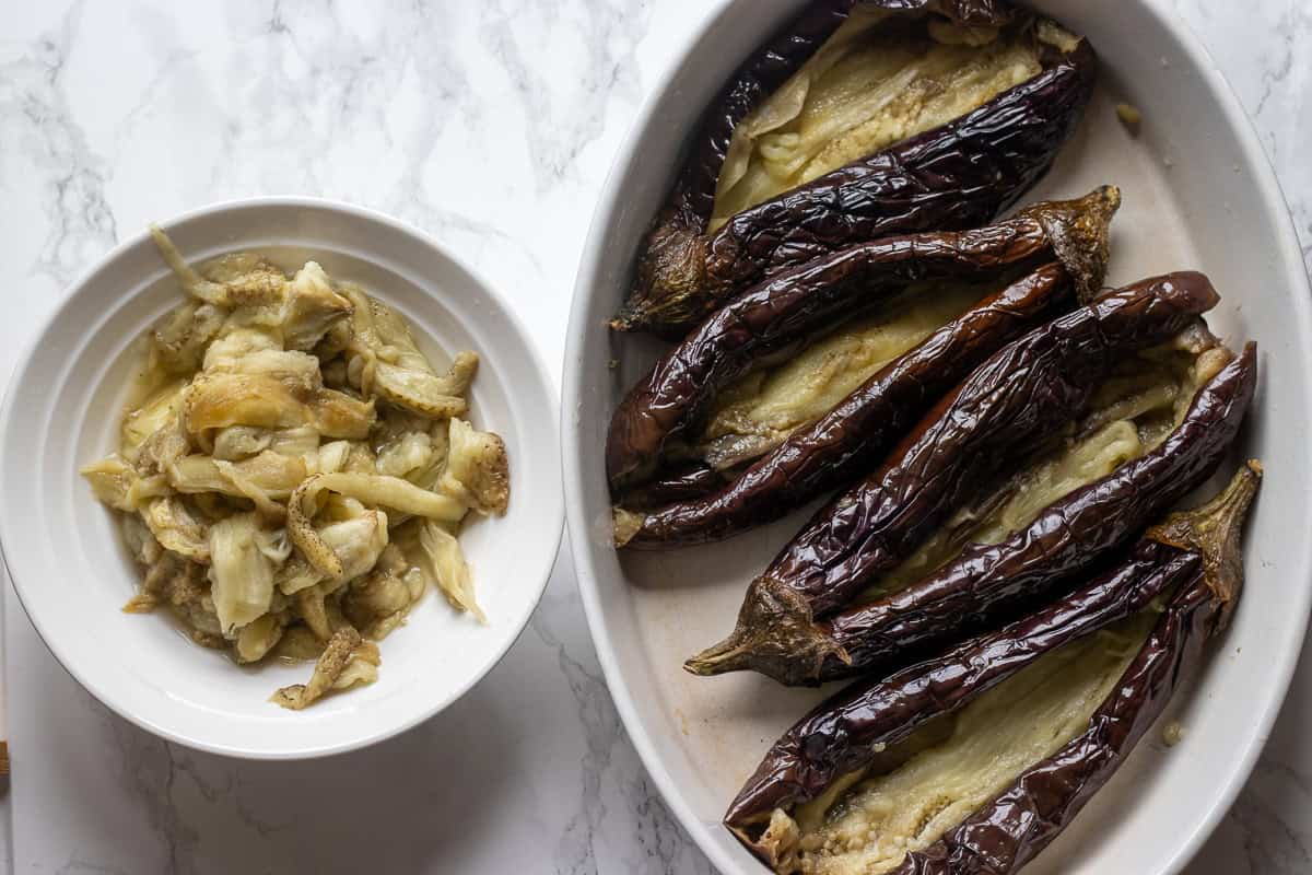 flesh of the eggplants are scooped out