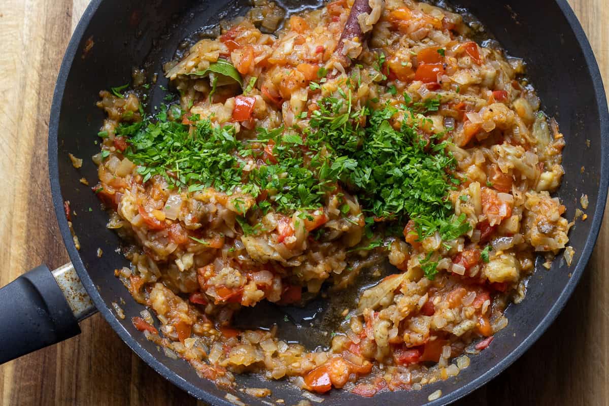 chopped parsley is added to papoutsakia stuffing