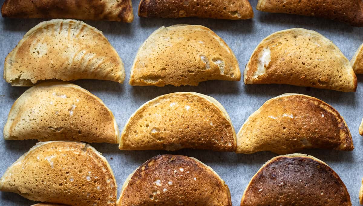 Qatayef are placed on a baking tray