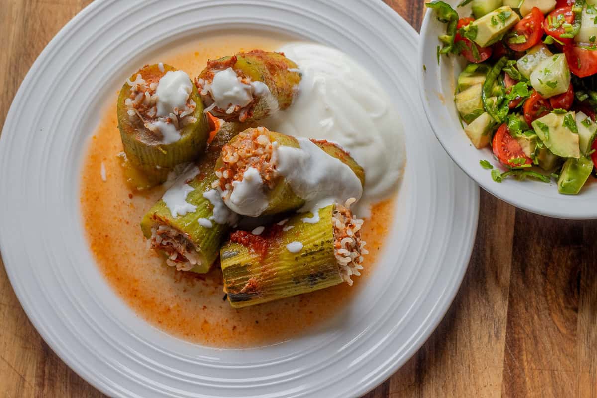kabak dolmasi - rice stuffed zucchinis served with a bowl of salad