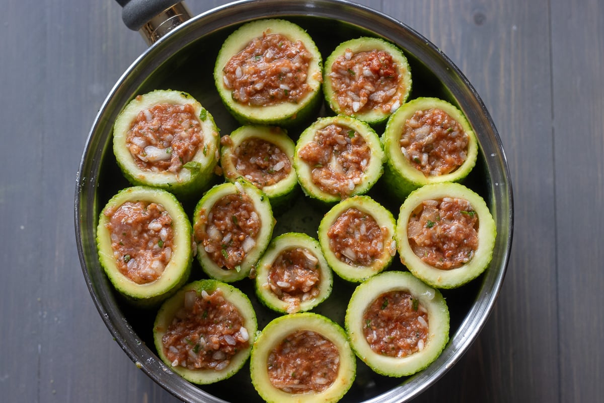 stuffed zucchinis are placed in a pot