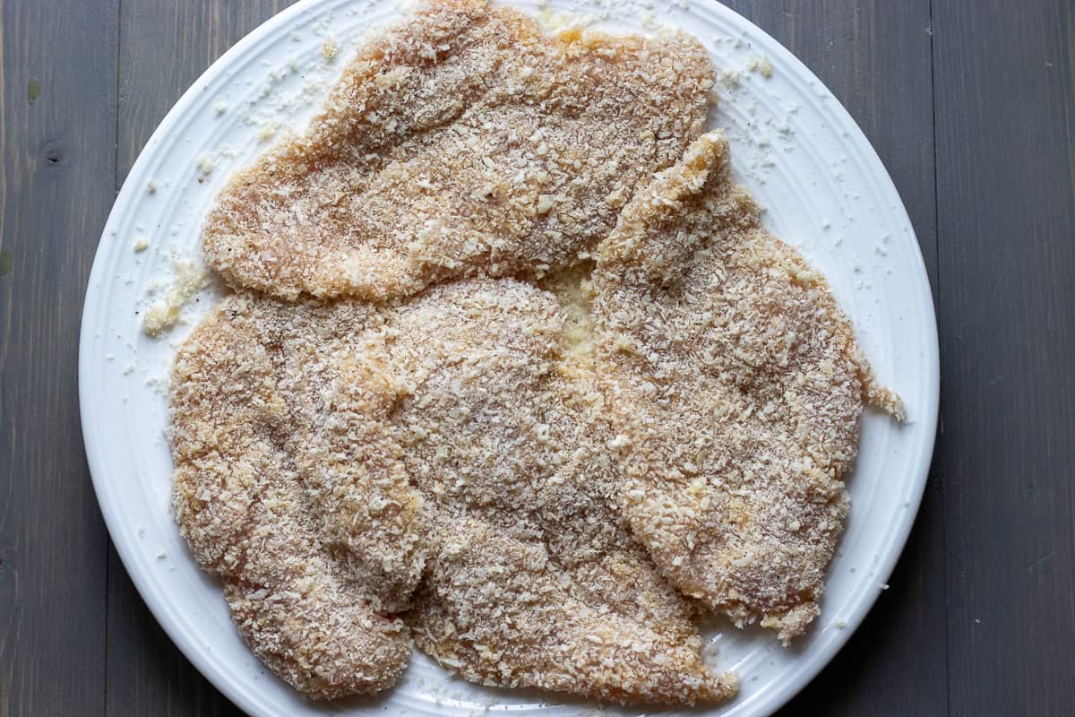 chicken cutlets are breaded with flour, egg, and breadcrumbs