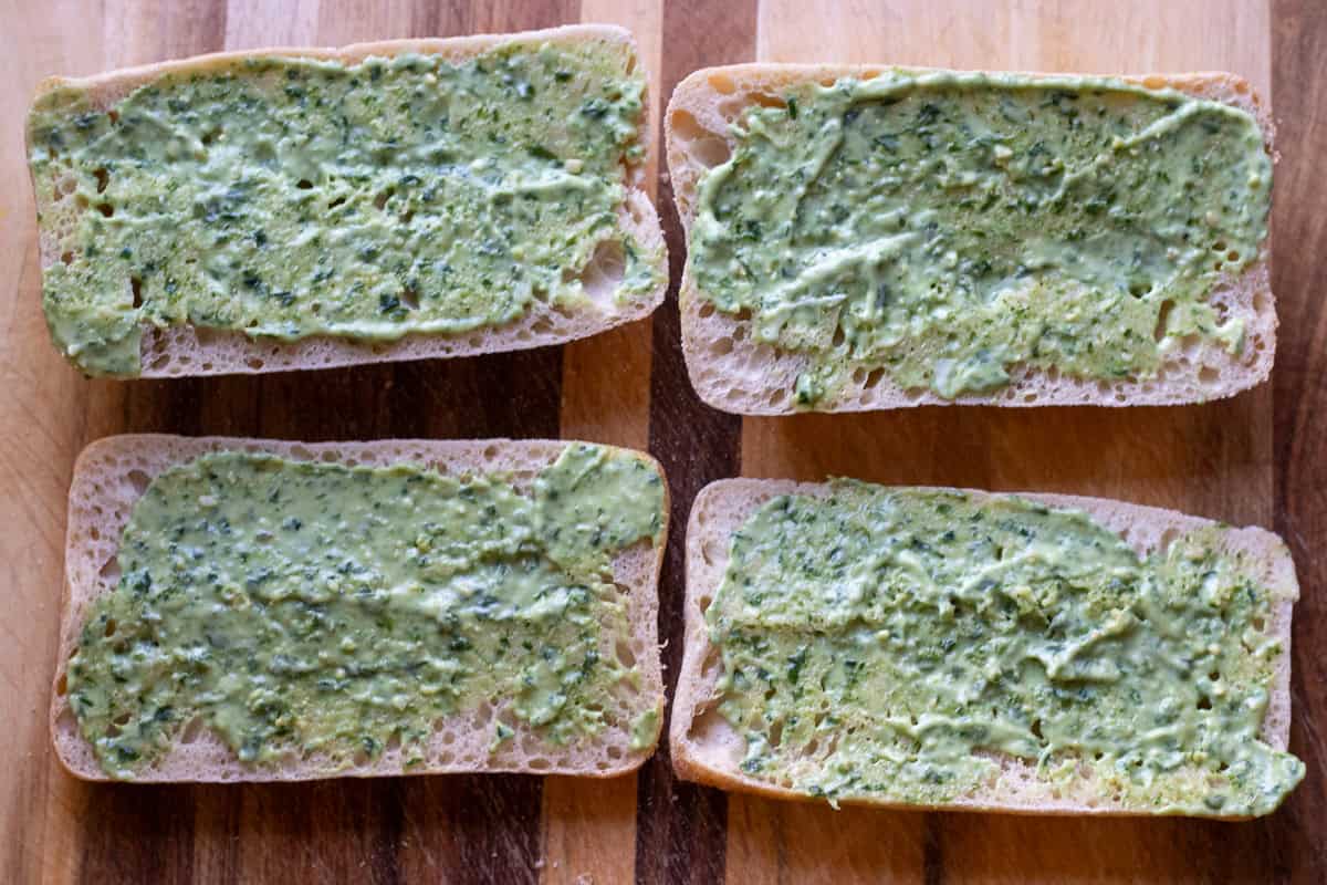 bread rolls are covered with pesto mayo mixture
