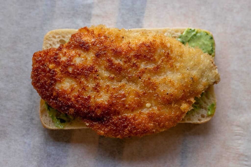 a piece of fried chicken cutlet placed on top of bread