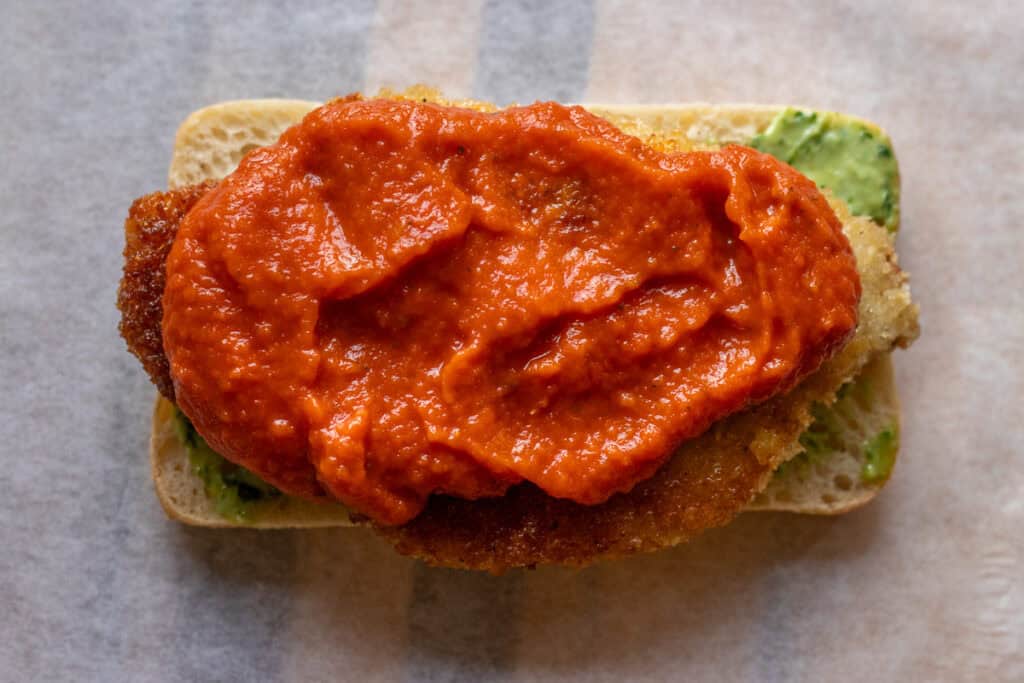 marinara sauce is spread on top of chicken