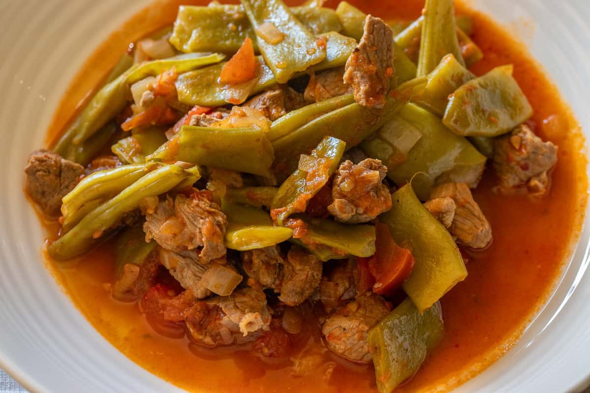 etli taze fasulye - green bean stew with meat served on a plate