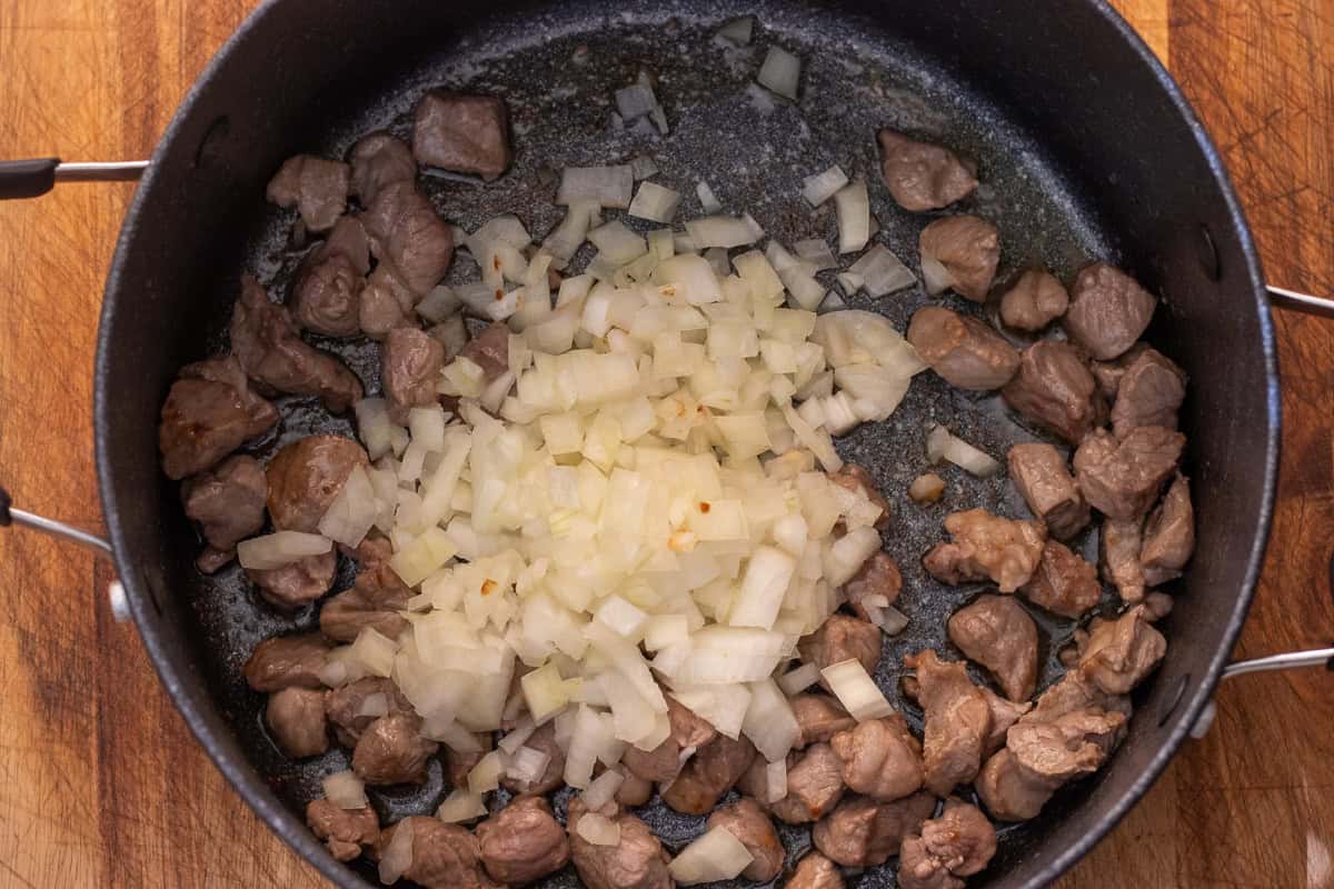 diced lamb is browned in olive oil before adding the onions