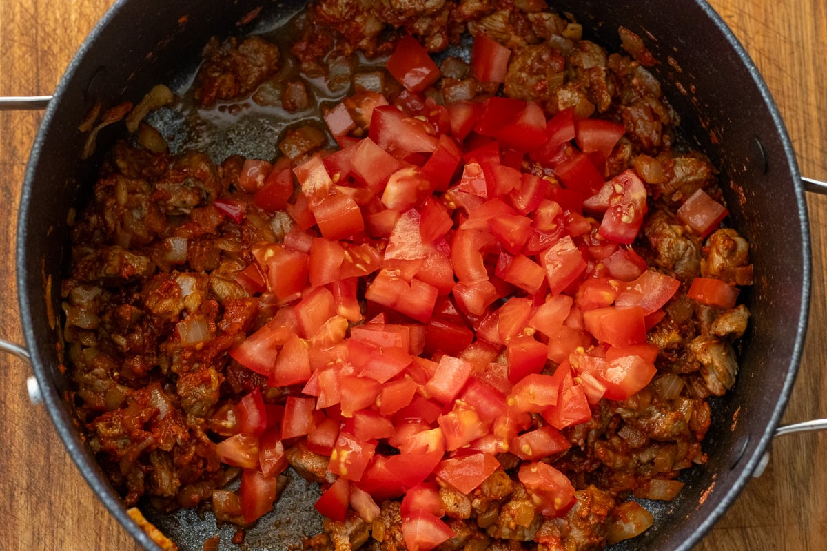 tomato paste and seasoning are added to the pot