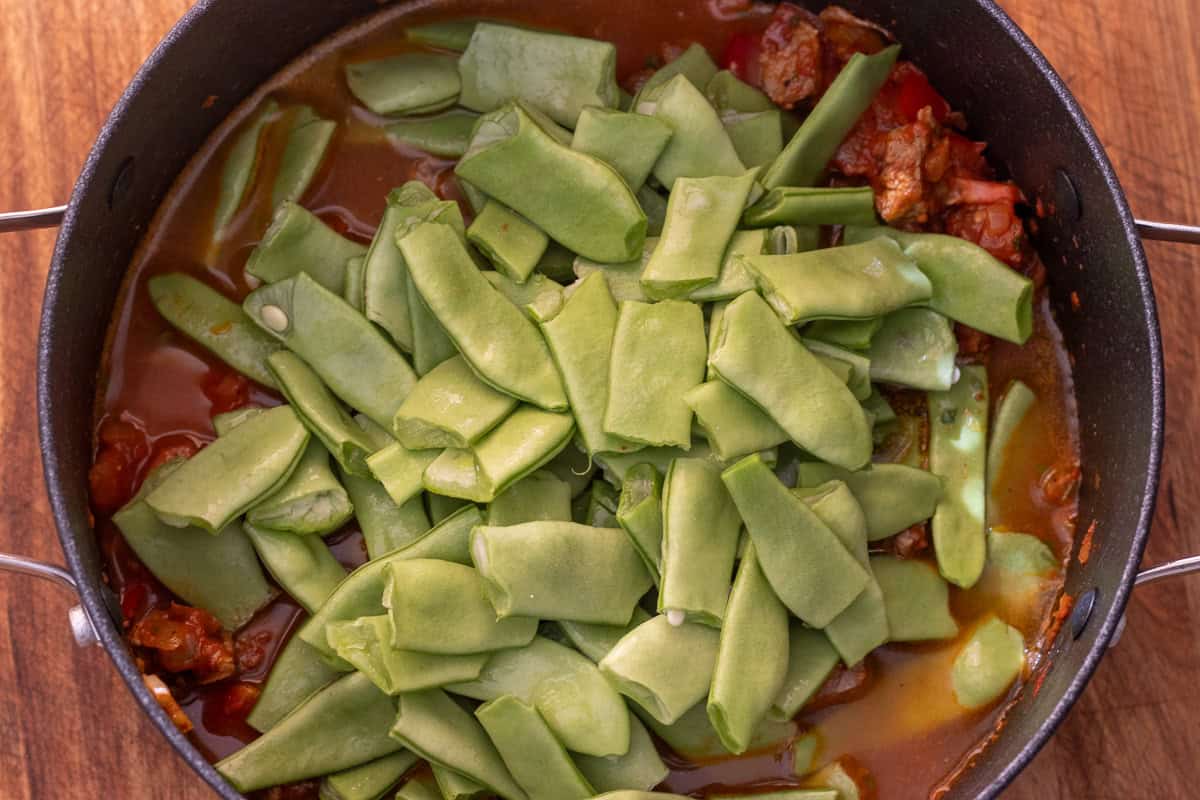 trimmed green beans are added to the pot