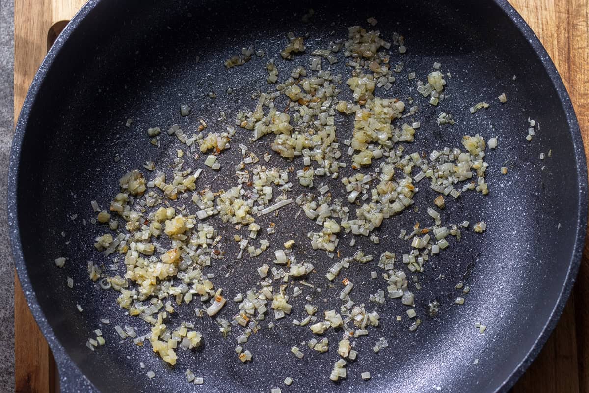 sautéing shallots with olive oil in a pan