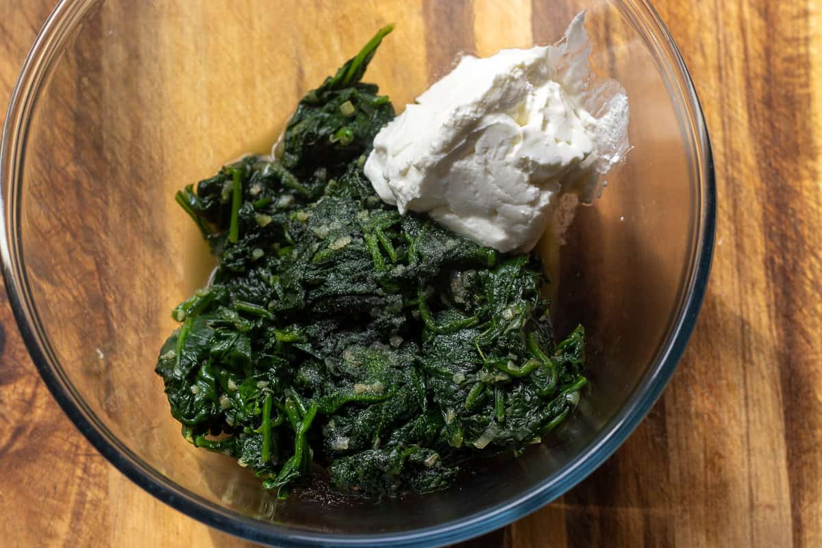 cooked spinach and yogurt are placed in a bowl