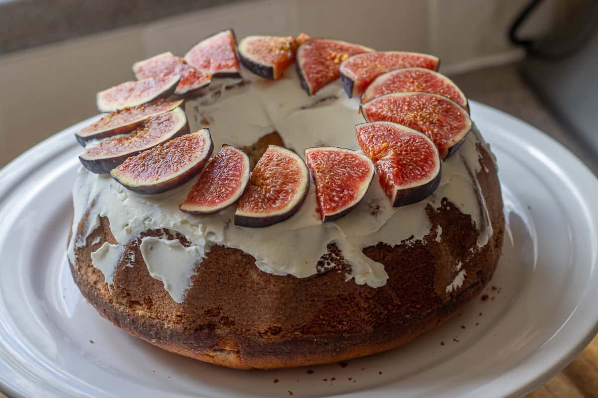 decorating freshly baked fig cake with fig slices