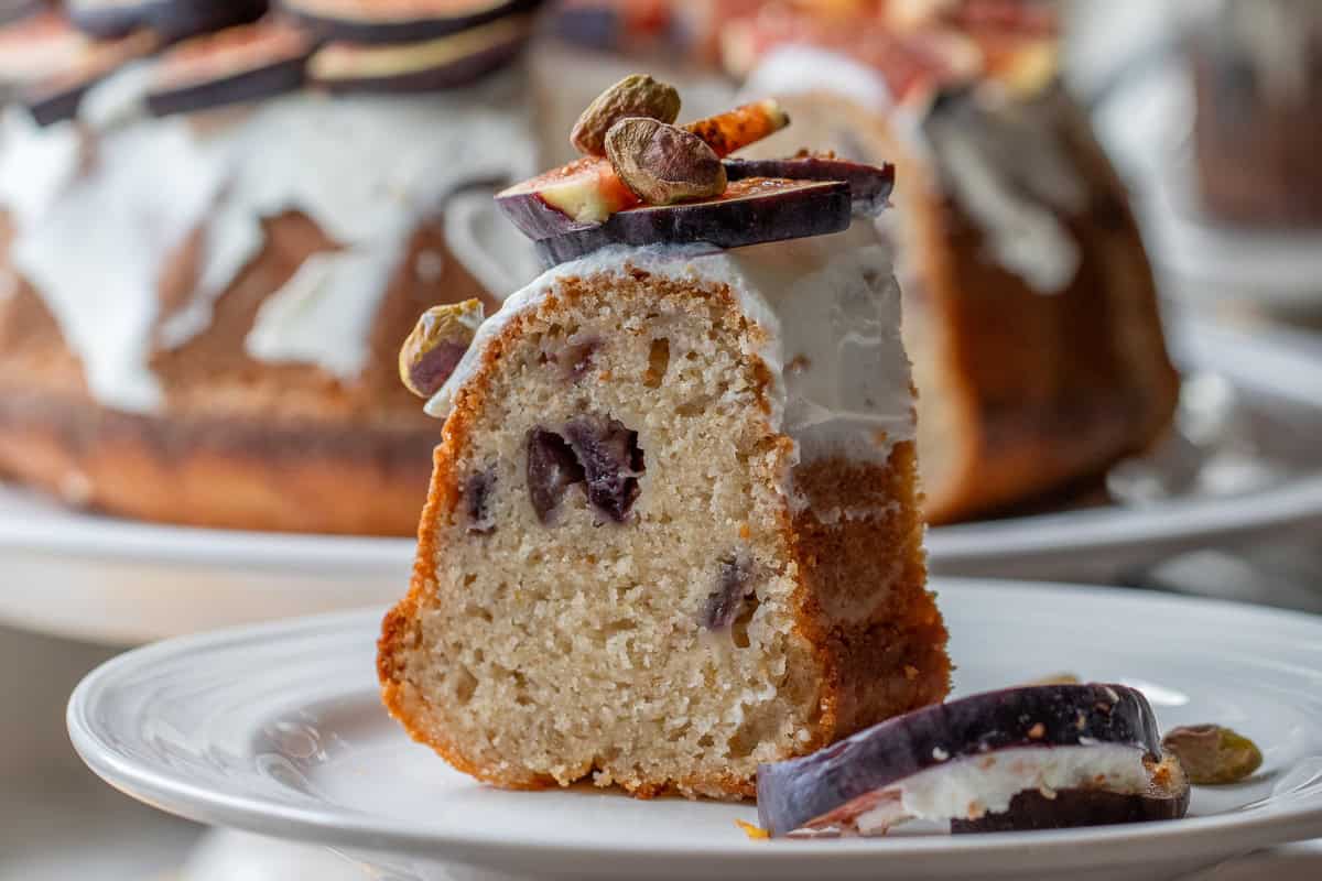 a slice of fresh fig cake served with sliced fresh figs