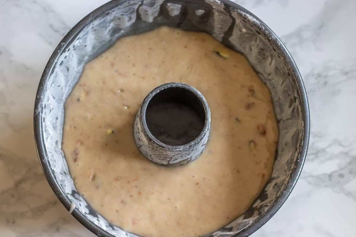 fig cake batter is poured in a bundt cake tin