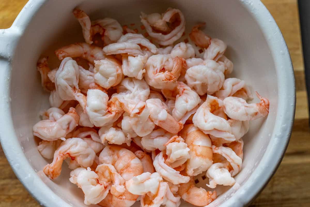cooked and cooled prawns on a colander
