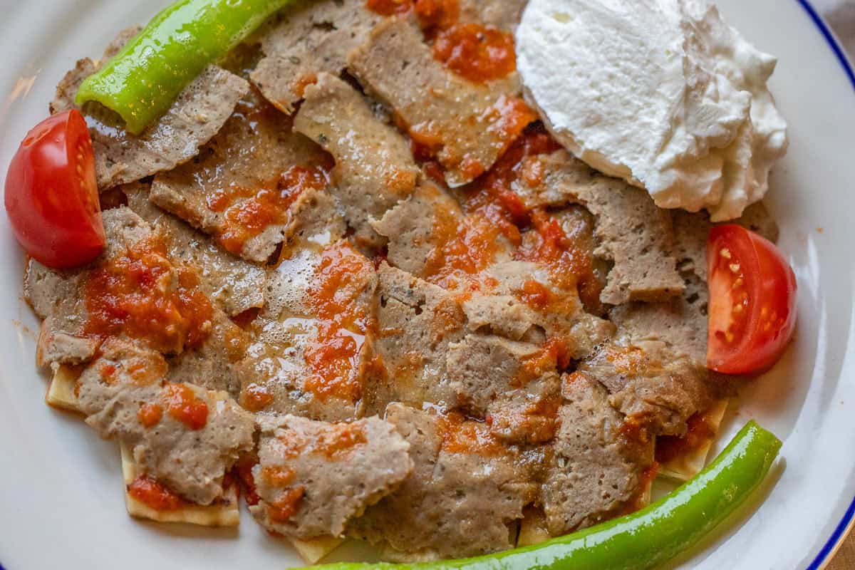 iskender kebab served with yogurt and veggies