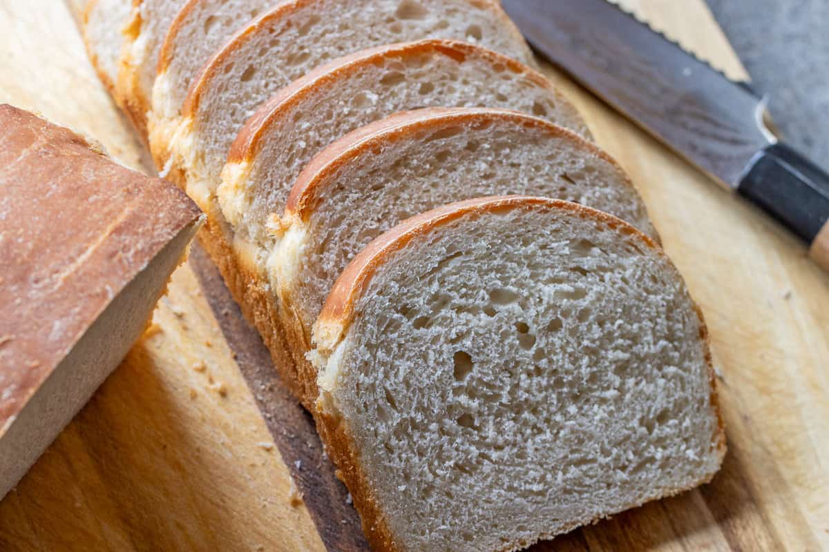Half of a sourdough sandwich bread cut into slices.